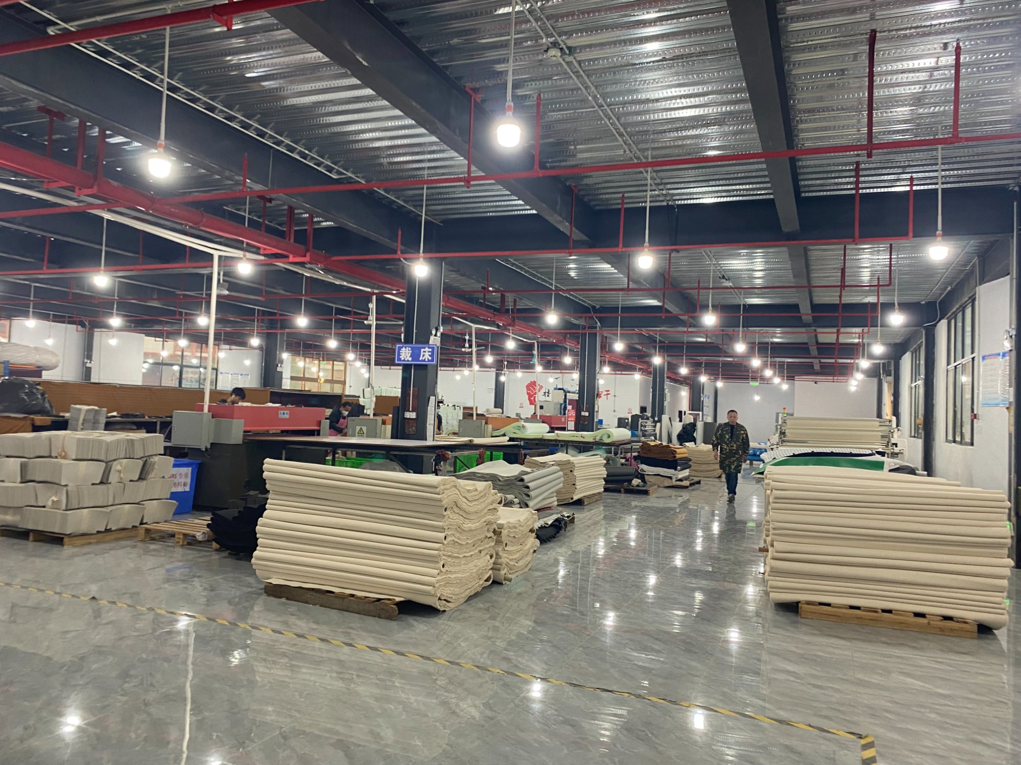 Modern cutting department with fabric rolls and equipment