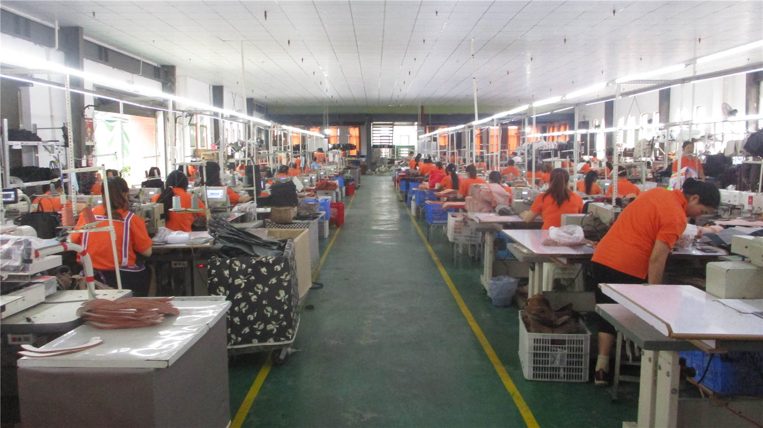 Large sewing floor with hundreds of workers at sewing stations